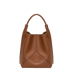 The Victoria Bucket by Victoria Beckham features a modern look in dark tan nappa leather, with a single handle, visible seam details, and the brand’s logo on the lower front.