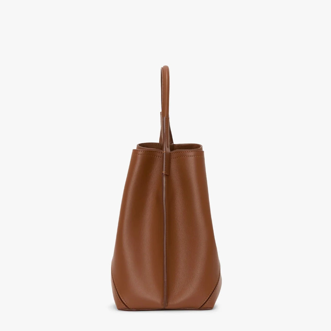 Side view of the Victoria Beckham Victoria Bucket bag in dark tan nappa leather, with a structured shape and single top handle, shown on a plain white background.