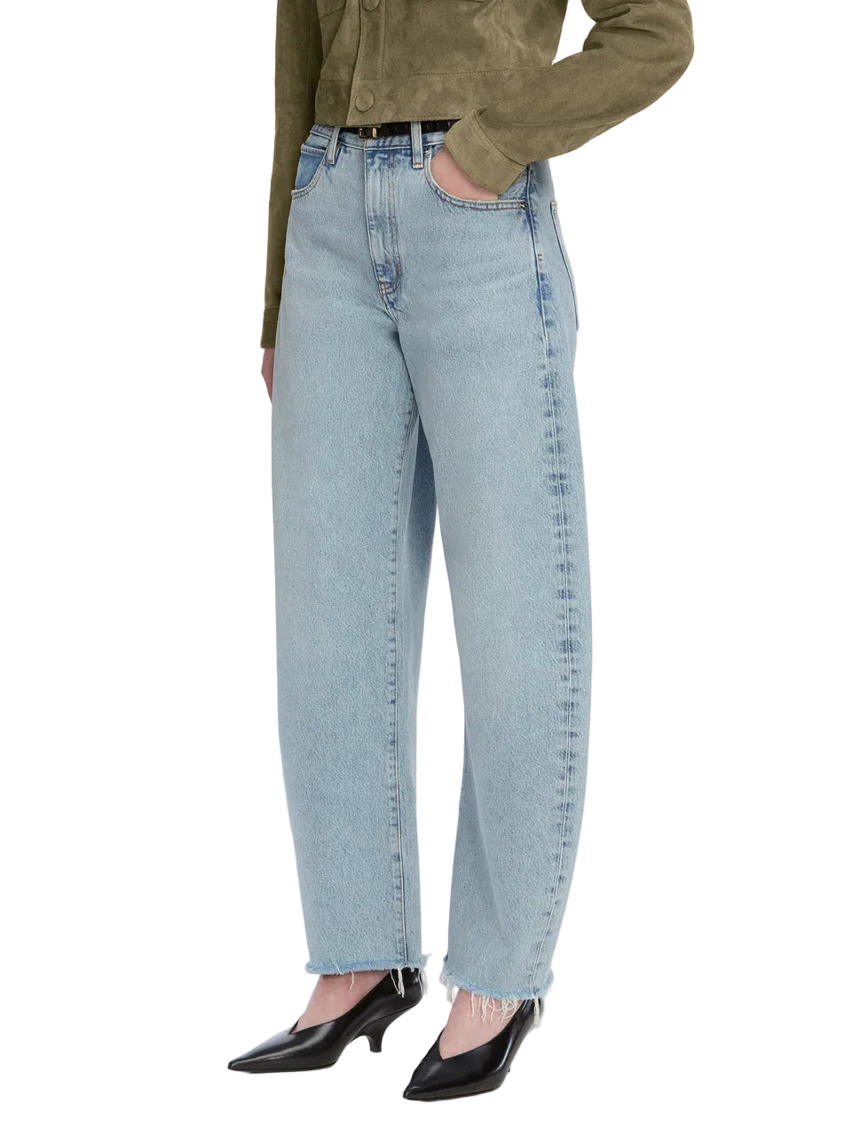 Person wearing The Bubble Crop high rise light blue barrel jeans by Frame with a raw hem, black belt, olive green jacket, and black pointed-toe heels.