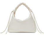 The Proenza Schouler Medium Drawstring Shoulder Bag is crafted from smooth leather, showcasing a white ruched design with a knotted strap and side ties. This minimalist piece is elegantly highlighted by a subtle gold foil logo on the plain background.