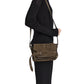 A person standing sideways wearing a black outfit with a brown suede Proenza Schouler Suede Beacon Saddle Bag on their shoulder.