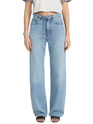 Person wearing The Off Duty Drawstring Bow high-waisted wide-leg jeans by Frame, styled with a cropped short-sleeve top and black open-toe shoes. The high-rise waist flatters the look; face not shown.