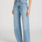 A person wears Frame's The Off Duty Drawstring Bow high-waisted, light blue barrel silhouette jeans with a drawstring belt, styled with a cropped striped top and dark sandals.