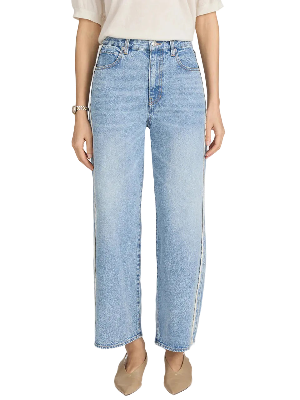 Wearing Frame's The Crochet Bow Crop top with light blue high-waisted wide-leg jeans featuring a raw hem and crochet trim, styled with beige pointed-toe flats.