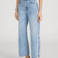 A person wears The Crochet Bow Crop by Frame with light wash, high-rise wide-leg jeans featuring a white side stripe and beige pointed-toe shoes, standing against a plain background.