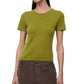 A woman wearing the Staud Easy Cashmere Tee in green, featuring short sleeves and a crew neckline, paired with brown pants stands against a plain white background.