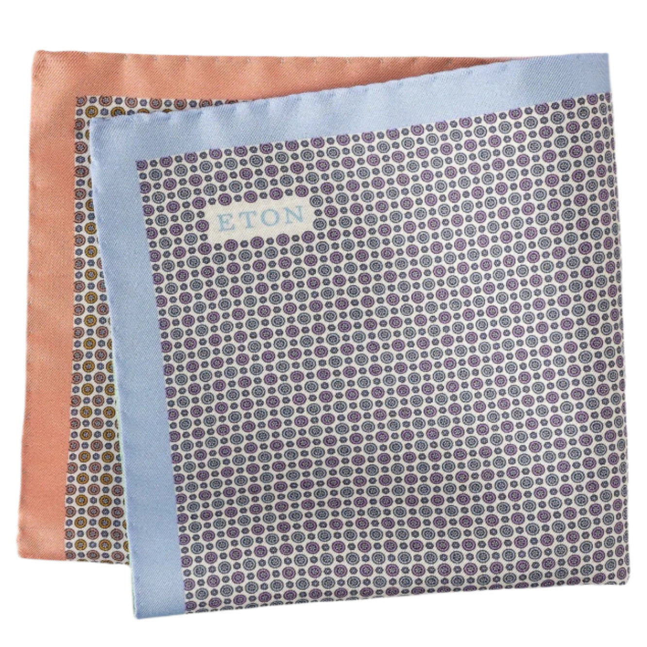 The Eton Four-Sided Silk Pocket Square showcases classic elegance with a small circular pattern and light blue-peach borders, expertly crafted from fine silk yarn.