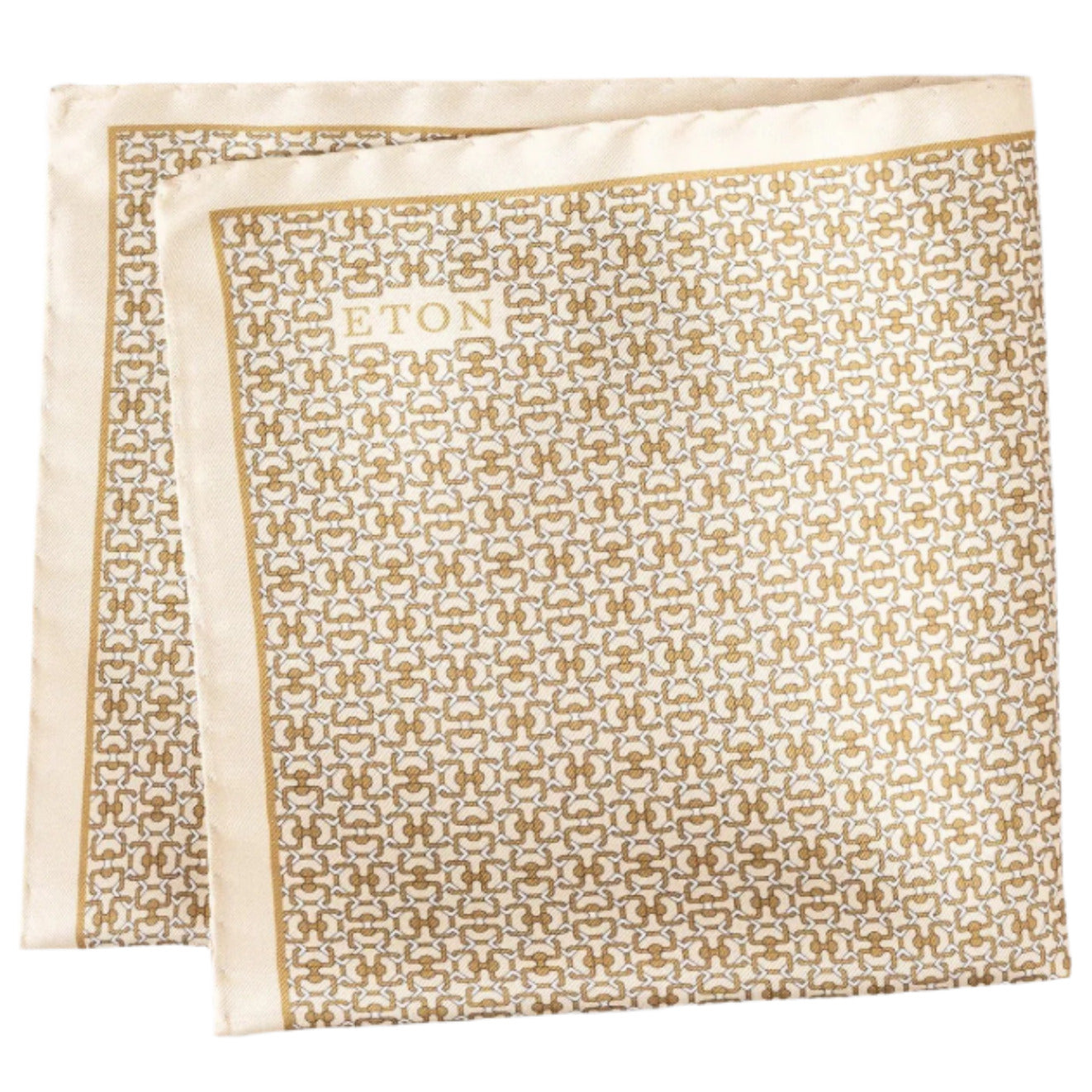 The Eton Geometric Silk Pocket Square features a folded cream and gold geometric print with "ETON" in the corner, made in Italy.