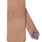 The Eton Geometric Print Silk Tie features an orange and blue geometric pattern, shown flat with its narrow end crossed over the wide end.