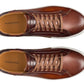 Top view of a pair of Magnanni Amadeo Sneakers in brown leather with white soles and brown laces. The brand name Magnanni is visible on the insole, reflecting the essence of contemporary cupsole fashion.