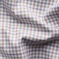 A close-up of Eton's Slim Cut Away Micro Check Twill Shirt, crafted from organic cotton with a brown, blue, and white micro check pattern.