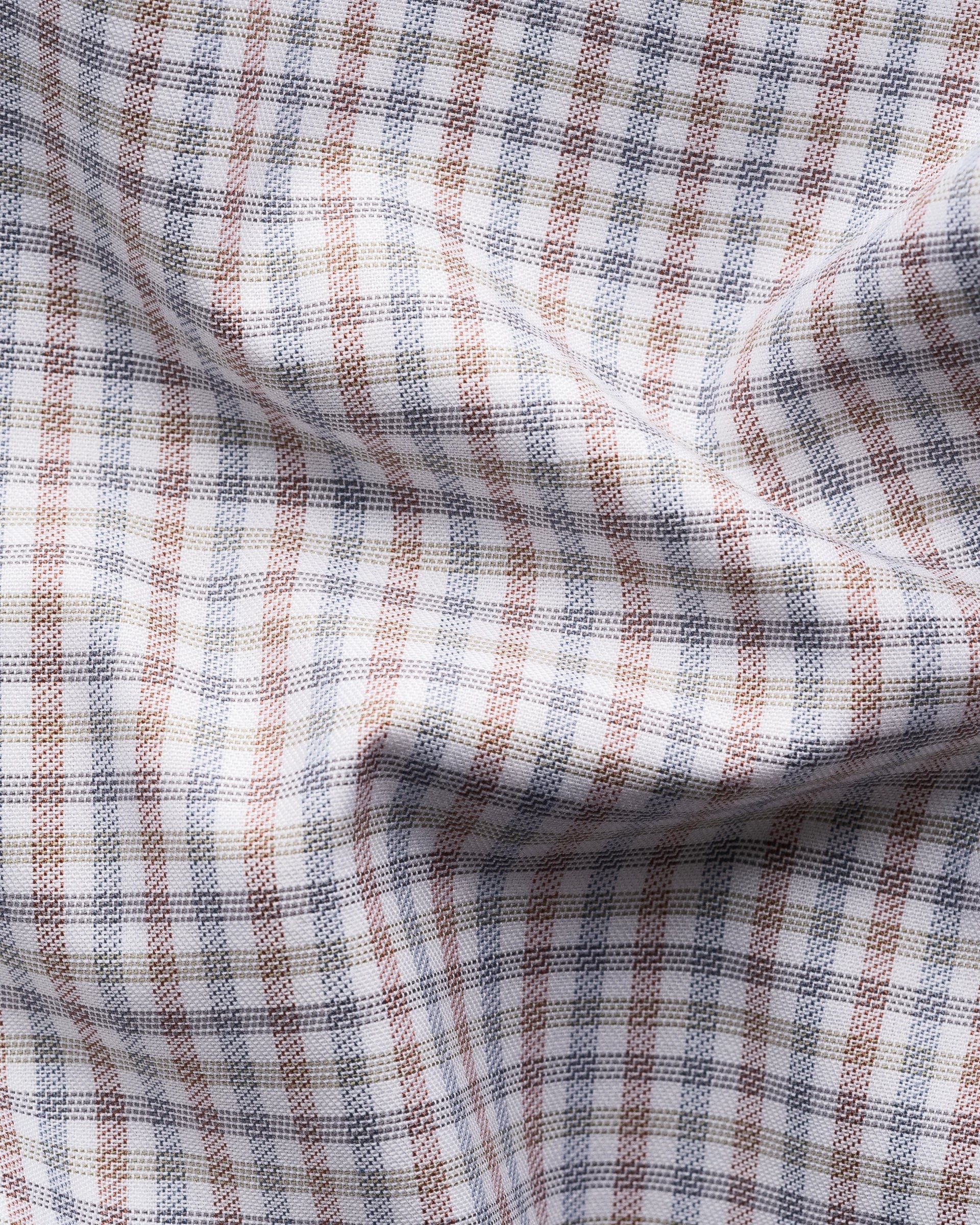 A close-up of Eton's Slim Cut Away Micro Check Twill Shirt, crafted from organic cotton with a brown, blue, and white micro check pattern.