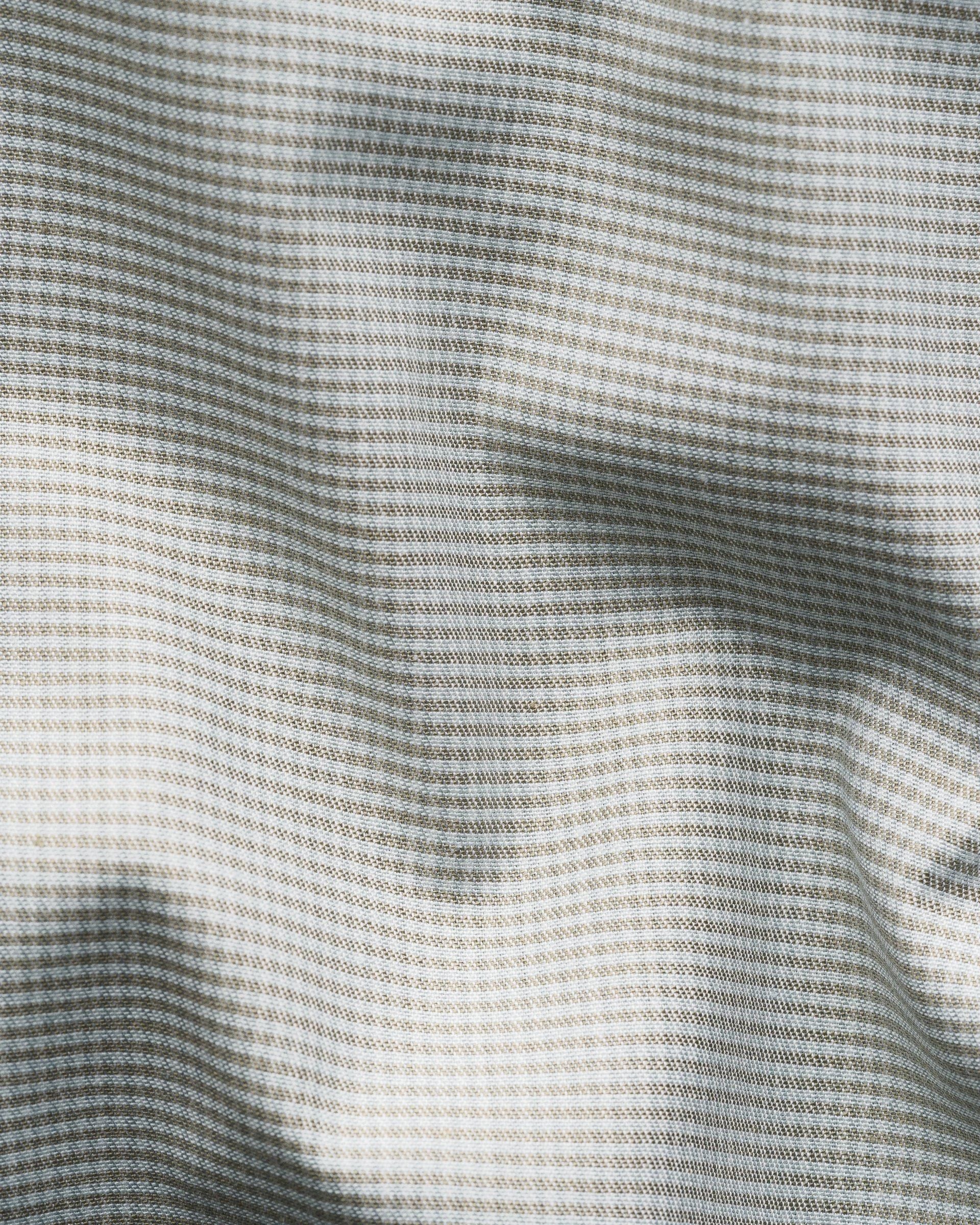 Close-up of the Eton Slim Wide Spread Micro Check Twill Shirt, showcasing its gray and white micro check pattern, textured weave, and soft folds—perfect for a wrinkle-resistant dress shirt.