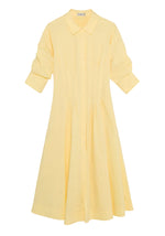 The Simkhai Jazz Pintuck Midi Dress, in light yellow cotton poplin, features a collar, long sleeves with button details, and an A-line silhouette, shown laid flat on a white background.