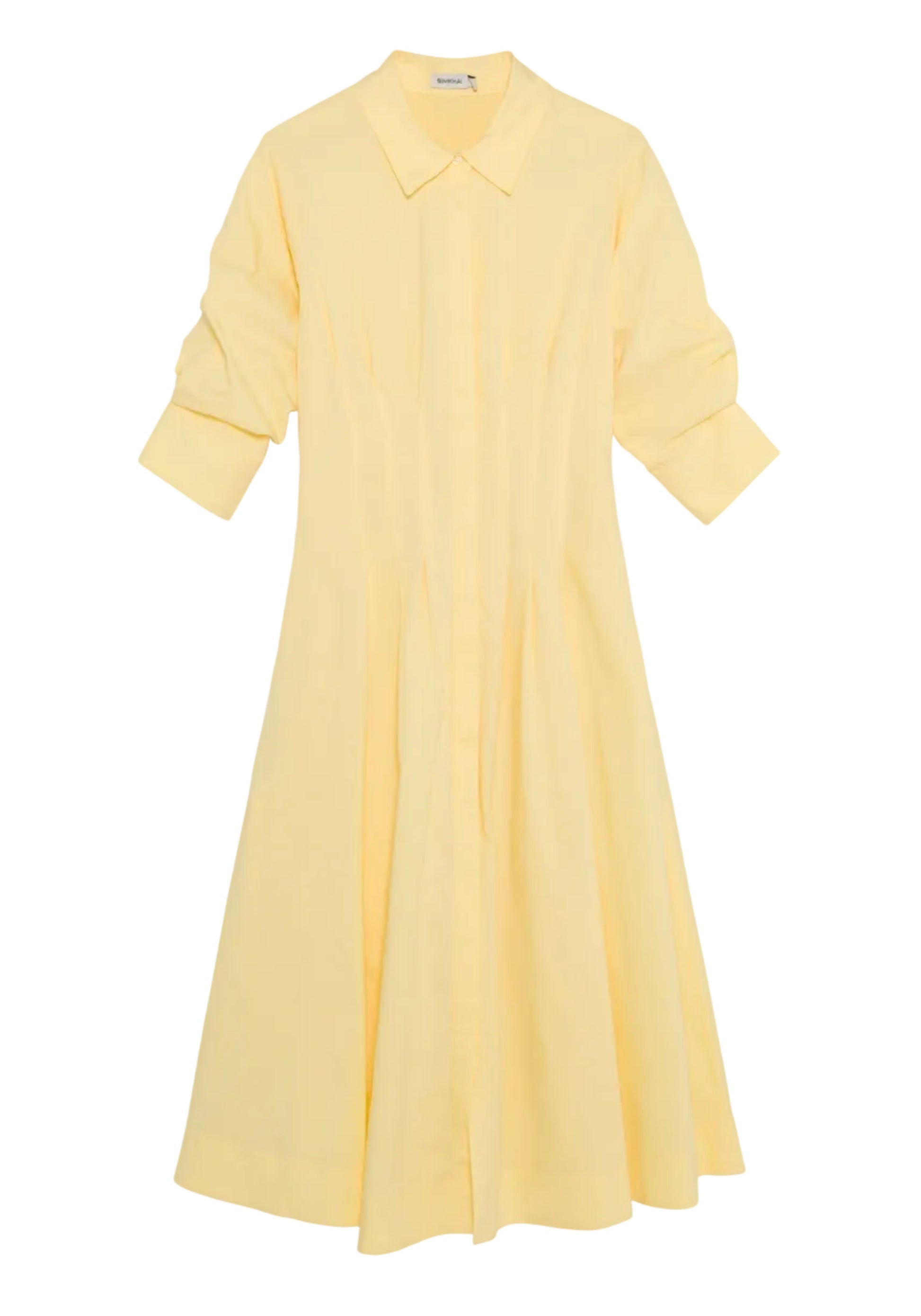 The Simkhai Jazz Pintuck Midi Dress, in light yellow cotton poplin, features a collar, long sleeves with button details, and an A-line silhouette, shown laid flat on a white background.