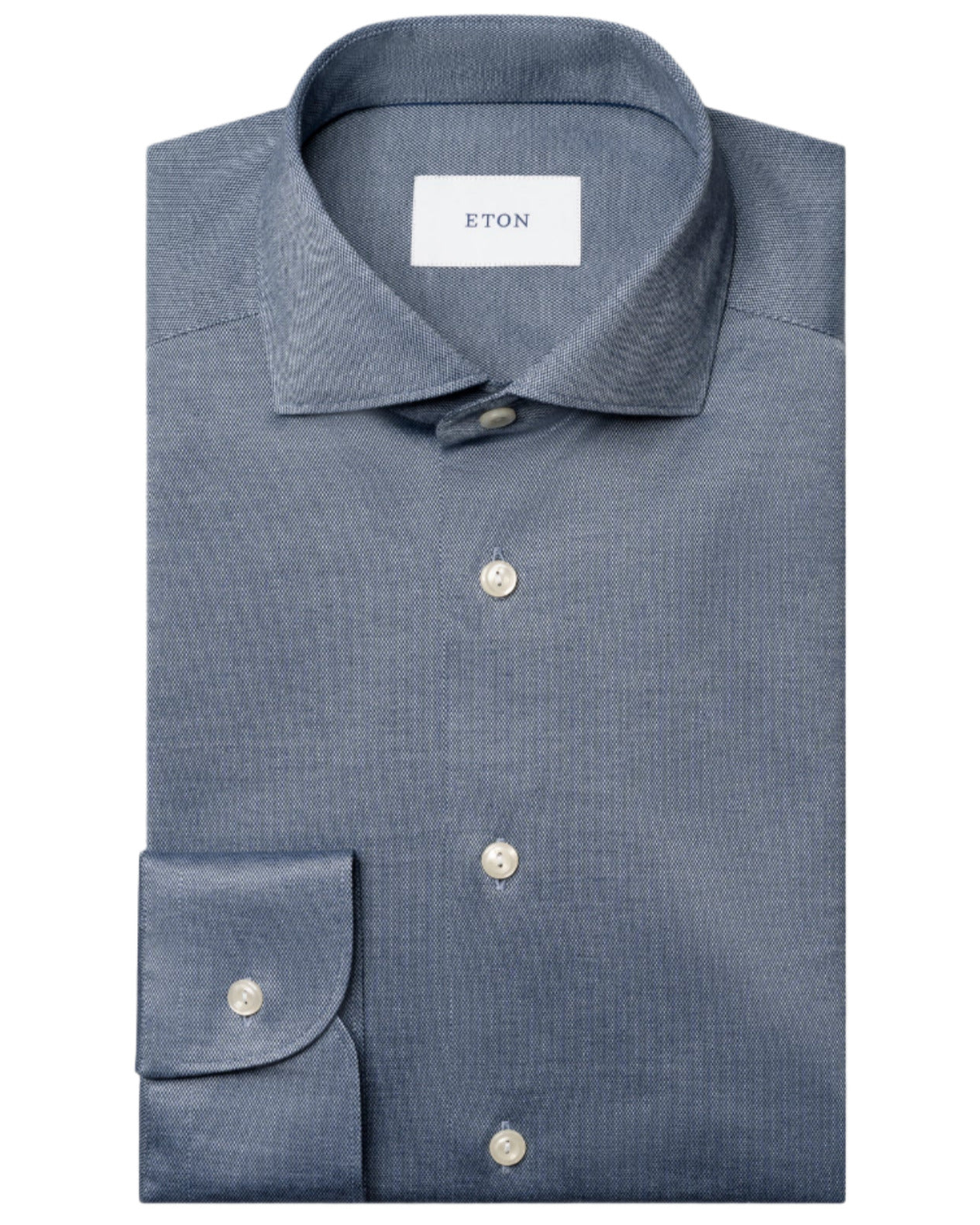 A neatly folded blue Slim Wide Spread Filo di Scozia Knit Shirt by Eton, featuring a classic collar, white buttons, and a visible "ETON" label inside the collar.