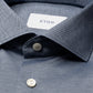 Close-up of a blue Slim Wide Spread Filo di Scozia Knit Shirt by Eton, featuring white buttons and a visible Eton label inside the collar.