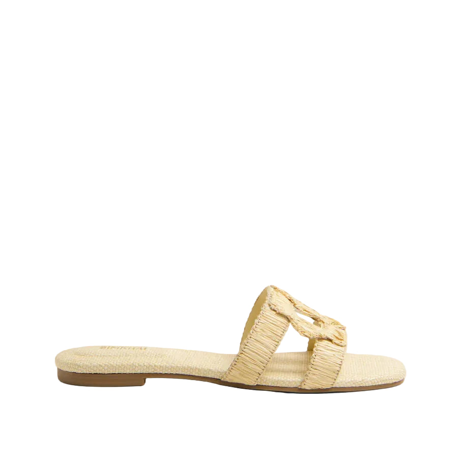 The Simkhai Monogram Raffia Flat Slide is a beige slip-on sandal featuring a woven texture and wide strap, ideal for upgrading your casual look with its signature Simkhai detailing.