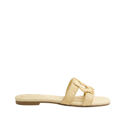 The Simkhai Monogram Raffia Flat Slide is a beige slip-on sandal featuring a woven texture and wide strap, ideal for upgrading your casual look with its signature Simkhai detailing.