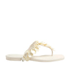 The Elin Natural Shell Beaded Thong Sandal by Simkhai is a cream flat sandal with a thong design, adorned with decorative beaded shell accents on the strap.