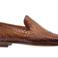 The Magnanni Herrera Woven Loafer, a hand-woven brown leather shoe with a flat heel, is elegantly displayed in a side view against a pristine white background.