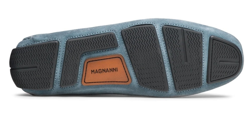 The image showcases the sole of a blue Magnanni Loira Loafer with black rubber grips and a tan leather patch labeled "MAGNANNI".