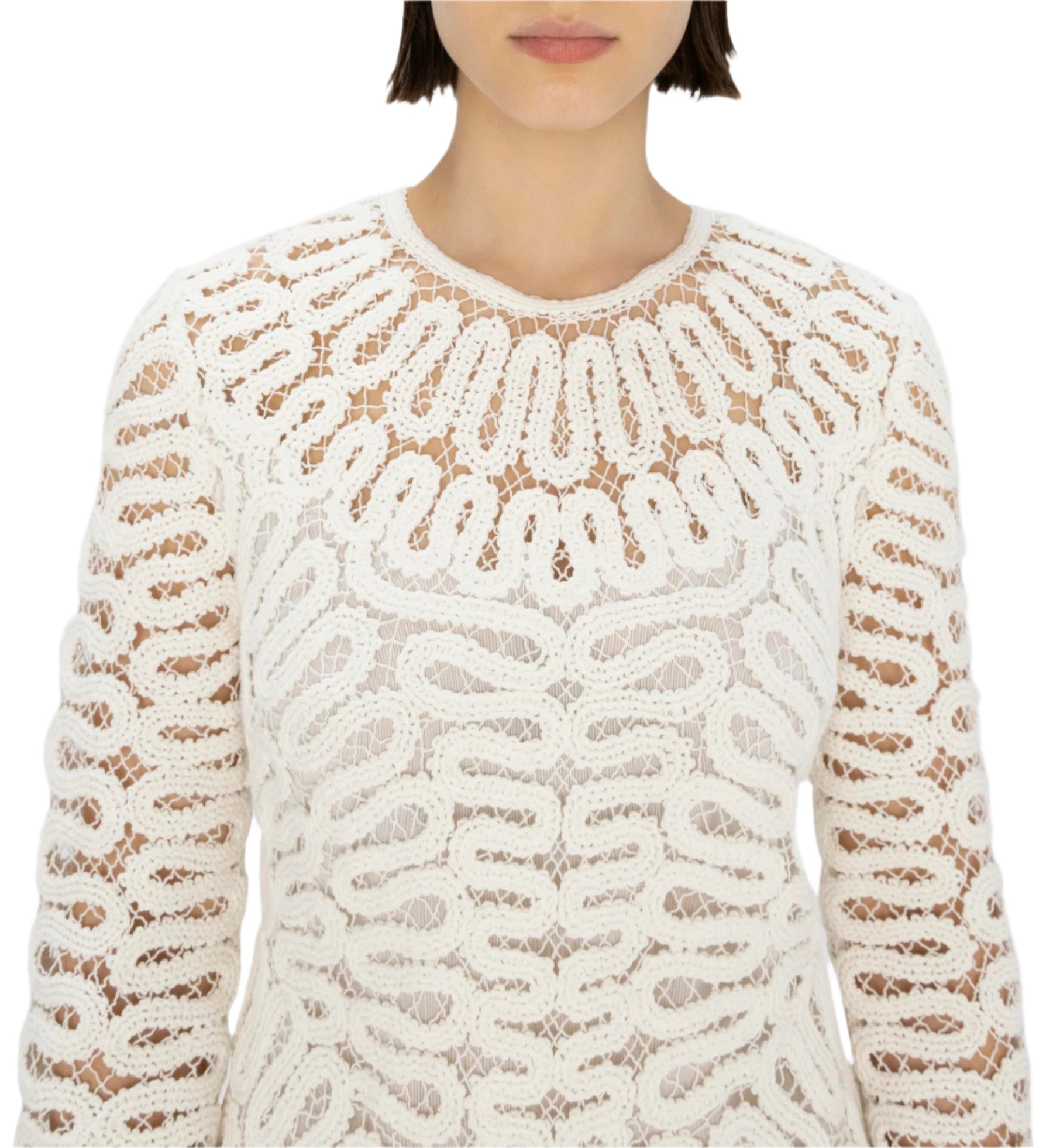 A woman models the Simkhai McCall Mini Dress, featuring white long sleeves with intricate crochet lace embroidery and a looped pattern, shown from shoulders to just above the waist.