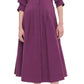 A person wearing the Simkhai Signature Jazz Dress, a purple, knee-length midi dress with elbow-length sleeves and elegant pintuck detailing, paired with beige heeled sandals from Simkhai.