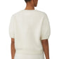 A person is shown from the back wearing the Lisa Yang Juniper Brushed Cashmere Sweater, a white, short-sleeve cropped style made from a soft, fuzzy knit.