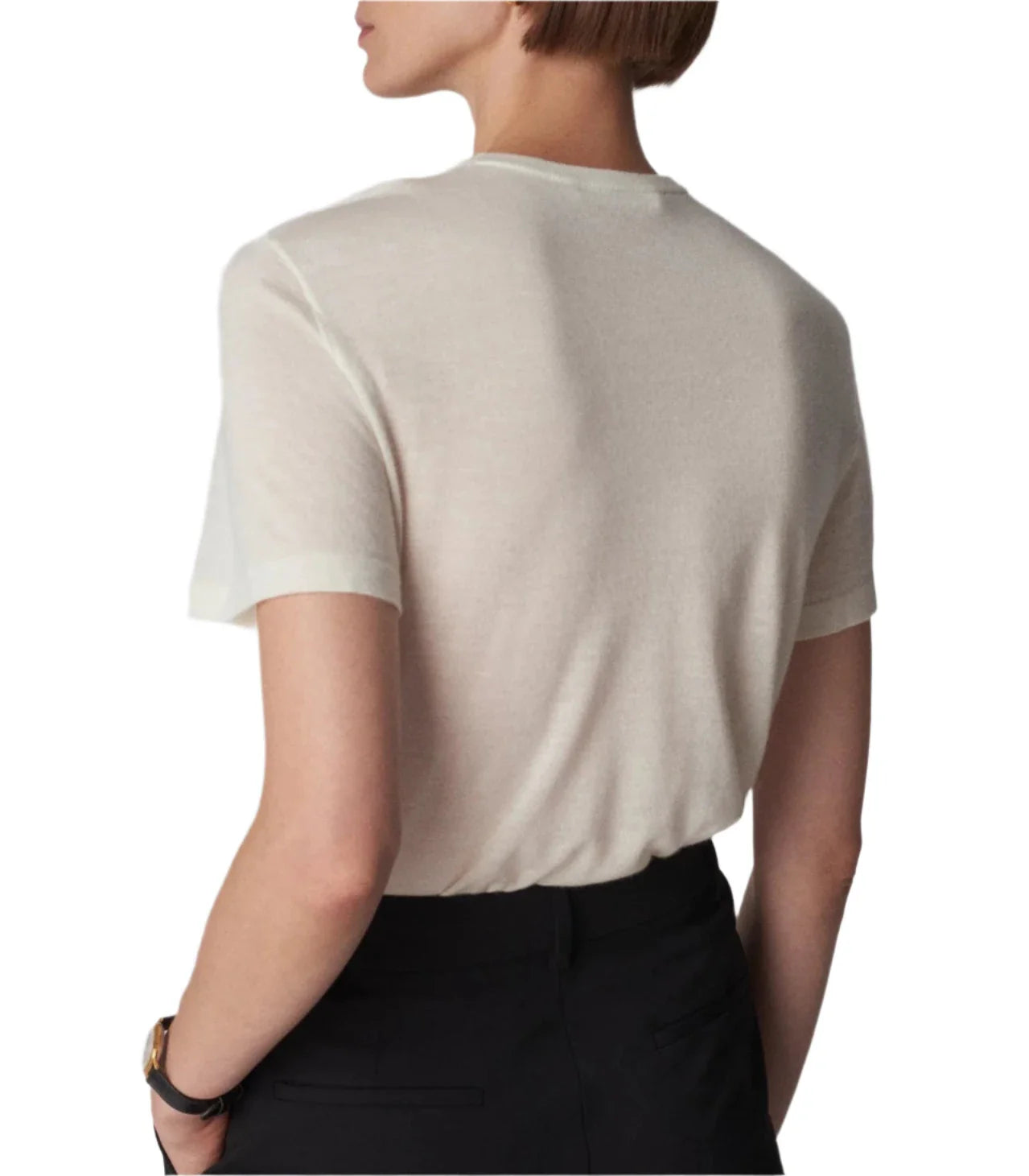 Person wearing a white, lightweight CO Cashmere Tee by CO and black pants, seen from the back with a short hairstyle, against a plain white background.