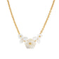 The Juliska Capucine De Wulf Mermaid Garden Bouquet Necklace is a gold link chain with three white carved flower and leaf accents at the center, creating a stunning statement piece.