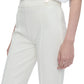 A person is elegantly dressed in Callas Milano's Lola Pant, crafted from stretch crepe knit, paired with a matching shirt, with one hand resting casually by their side.