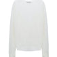 A white, long-sleeved, crew-neck Dorothee Schumacher Summer Ease Cardigan with asymmetric cuffs displayed on a plain background.