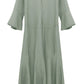 A sage green, long-sleeve linen blend Dorothee Schumacher Summer Cruise Maxi Dress with a loose fit, maxi length, tiered ruffle sleeves, V-neckline, and a back zip closure by Dorothee Schumacher.