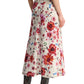 The person is wearing the Dorothee Schumacher Floral Ease Skirt with rolled-up sleeves, brown leather boots, and a chic leather tie belt, viewed from the side.