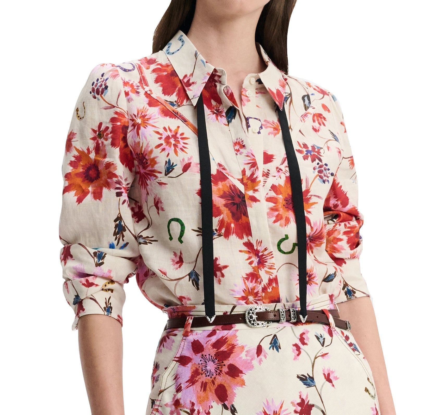 A person wears the Dorothee Schumacher Floral Ease Blouse, styled with suspenders and a belt, exuding a touch of Western-inspired flair.