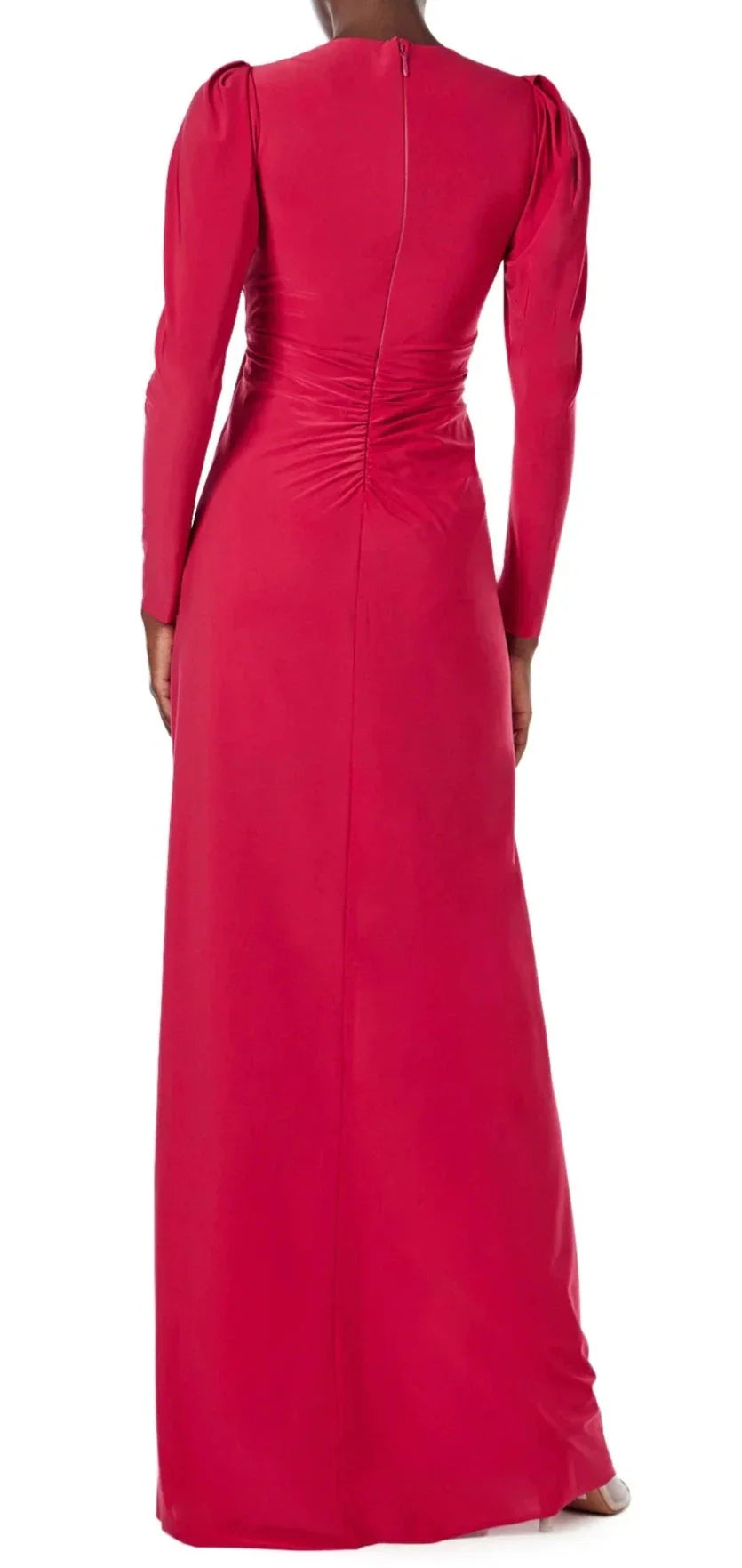 A person is shown from the back, wearing a Monique Lhuillier Jewel Neck Long Sleeve Draped Gown in red. The dress features ruching at the waist, a high front skirt slit, and a zipper closure at the back.