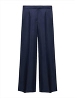 Dorothee Schumacher's Trench It Up Pants are navy blue silk twill wide-leg trousers featuring pleats, a comfortable waistband, and side pockets, all set against a white background.