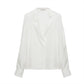 The Trench It Up Blouse by Dorothee Schumacher is a white silk twill long-sleeve top with a fluid drape and an asymmetric notched lapel collar, showcased on a plain background.