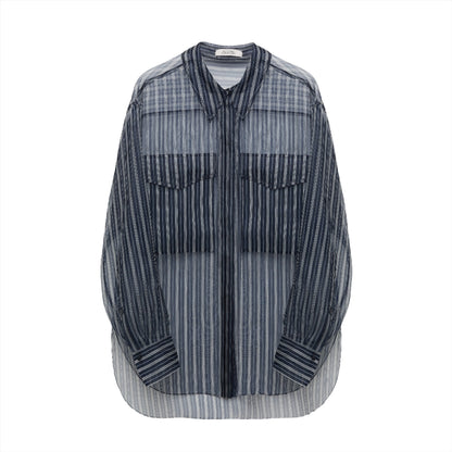 The Dorothee Schumacher Transparent Stripe Blouse by Dorothee Schumacher is a blue and white striped button-up shirt with an oversized silhouette, featuring long sleeves and two front chest pockets, displayed on a plain white background.