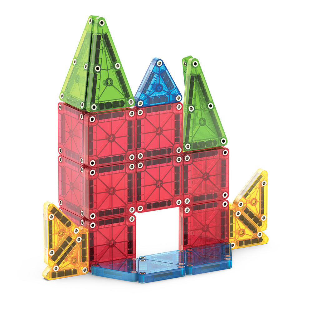 A bright house or castle with two tall roofs is built from the microMAGS Travel 26-Piece Set by Magnatiles, using magnetic tiles in red, green, blue, and yellow.