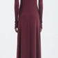 Model shown from the back wearing the Maria McManus Rib Godet Dress in merlot, an ankle-length, long-sleeved design, set against a plain light background.