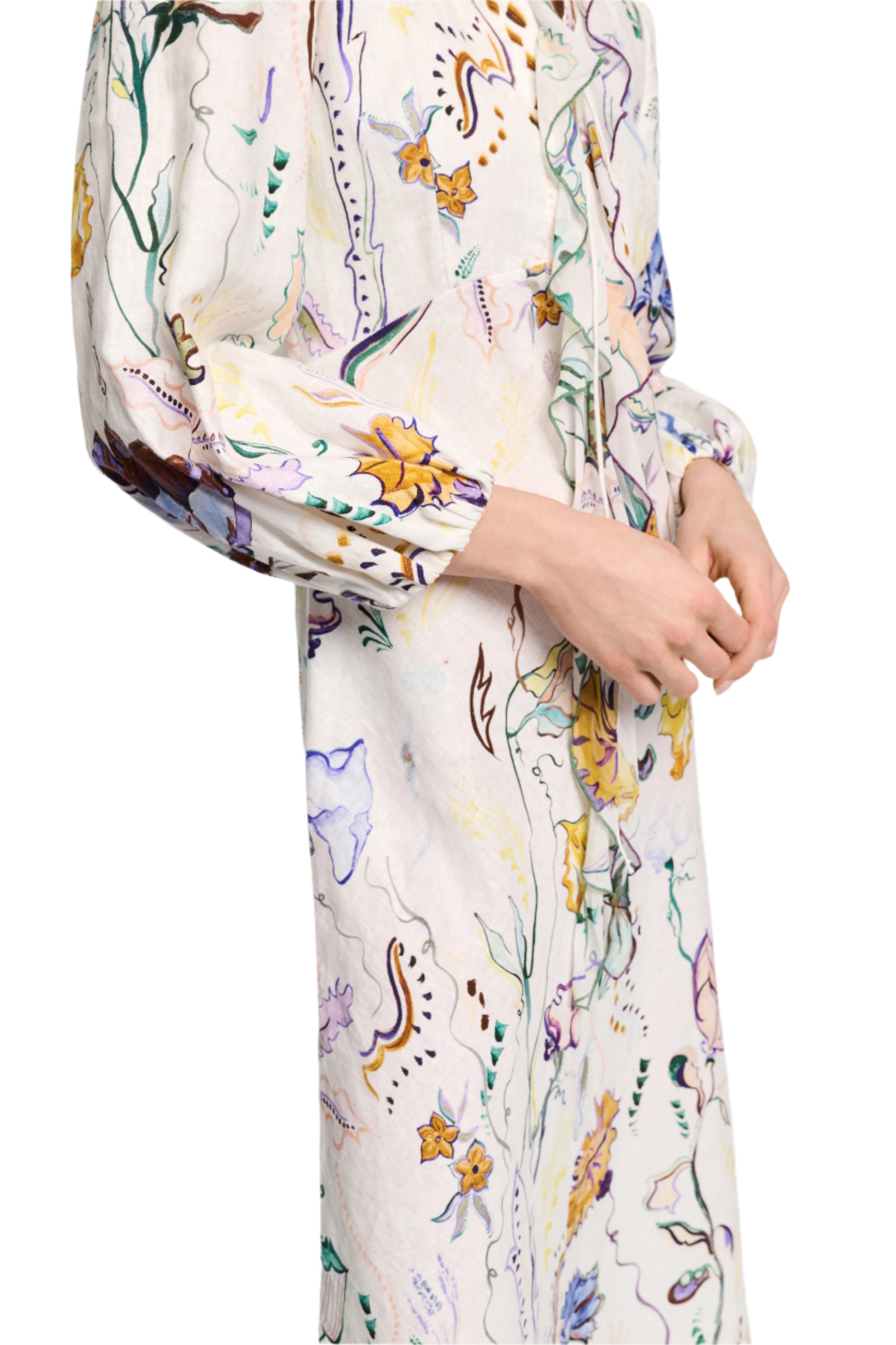 A person is wearing the Dorothee Schumacher Floral Power Maxi Dress, a long-sleeved, colorful floral printed linen dress featuring a charming lace-up front.