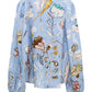 Dorothee Schumacher Floral Power Blouse in blue linen with a floral pattern features long sleeves and a V-neckline.