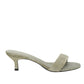 The Dorothee Schumacher Suede Sensation Kitten Heel is a single light green suede sandal featuring an open toe, slim kitten heel, and a stylish padded strap on a white background.