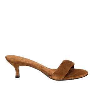 Brown suede medium-heel sandal named "Suede Sensation Kitten Heel" by Dorothee Schumacher features a single wide padded strap and thin kitten heel, displayed on a white background.