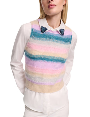 A person wears the Dorothee Schumacher Luxury Love Top, a soft cashmere yarn vest in pastel stripes, layered over a white collared shirt with beaded collar tips.