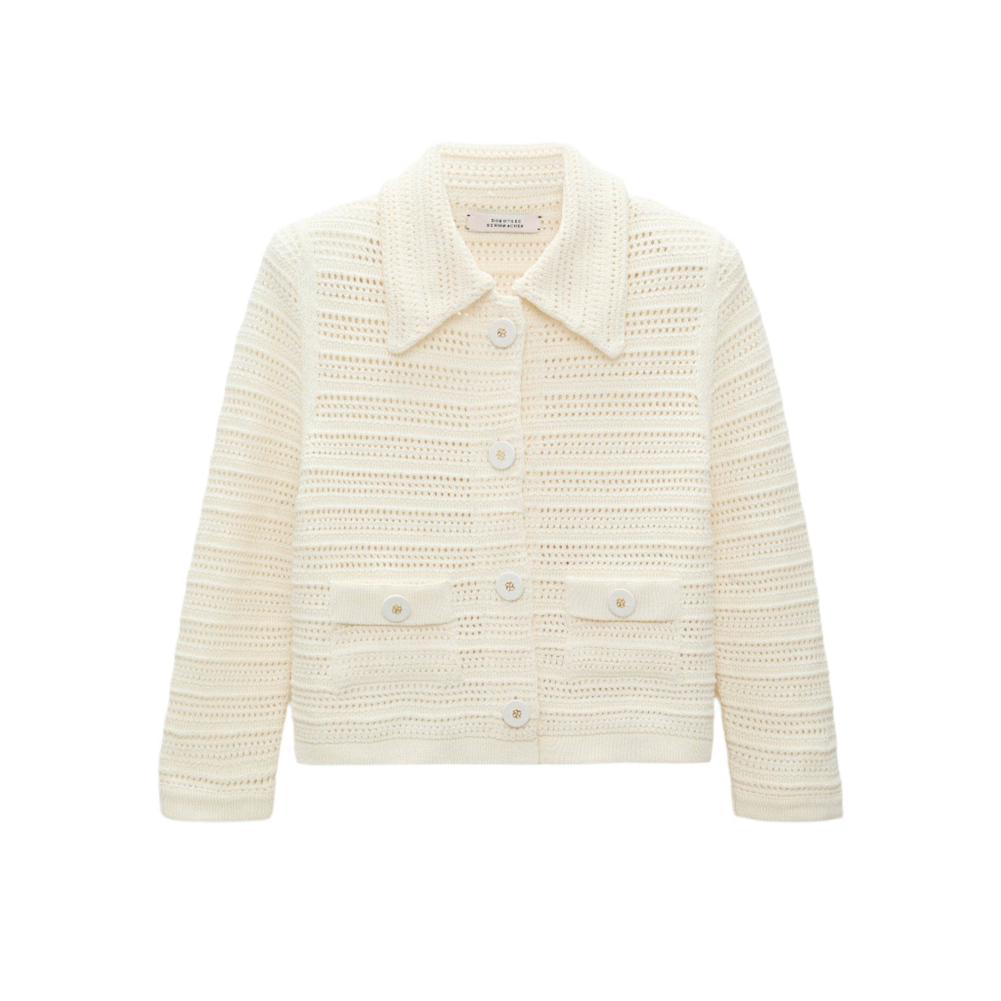The Precise Pointelle Jacket by Dorothee Schumacher is cream-colored, long-sleeve, and cropped with a graphic pointelle design, collar, front buttons, and two front pockets, shown on a white background.