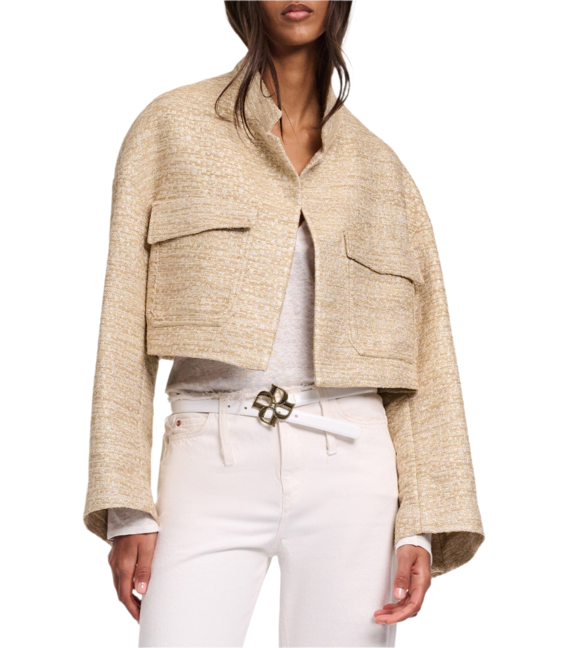 A woman wears the Dorothee Schumacher Shiny Coolness Jacket, a beige Lurex-tweed piece with large front pockets, styled with a white shirt, pants, and a gold-buckled belt for a chic boxy look.