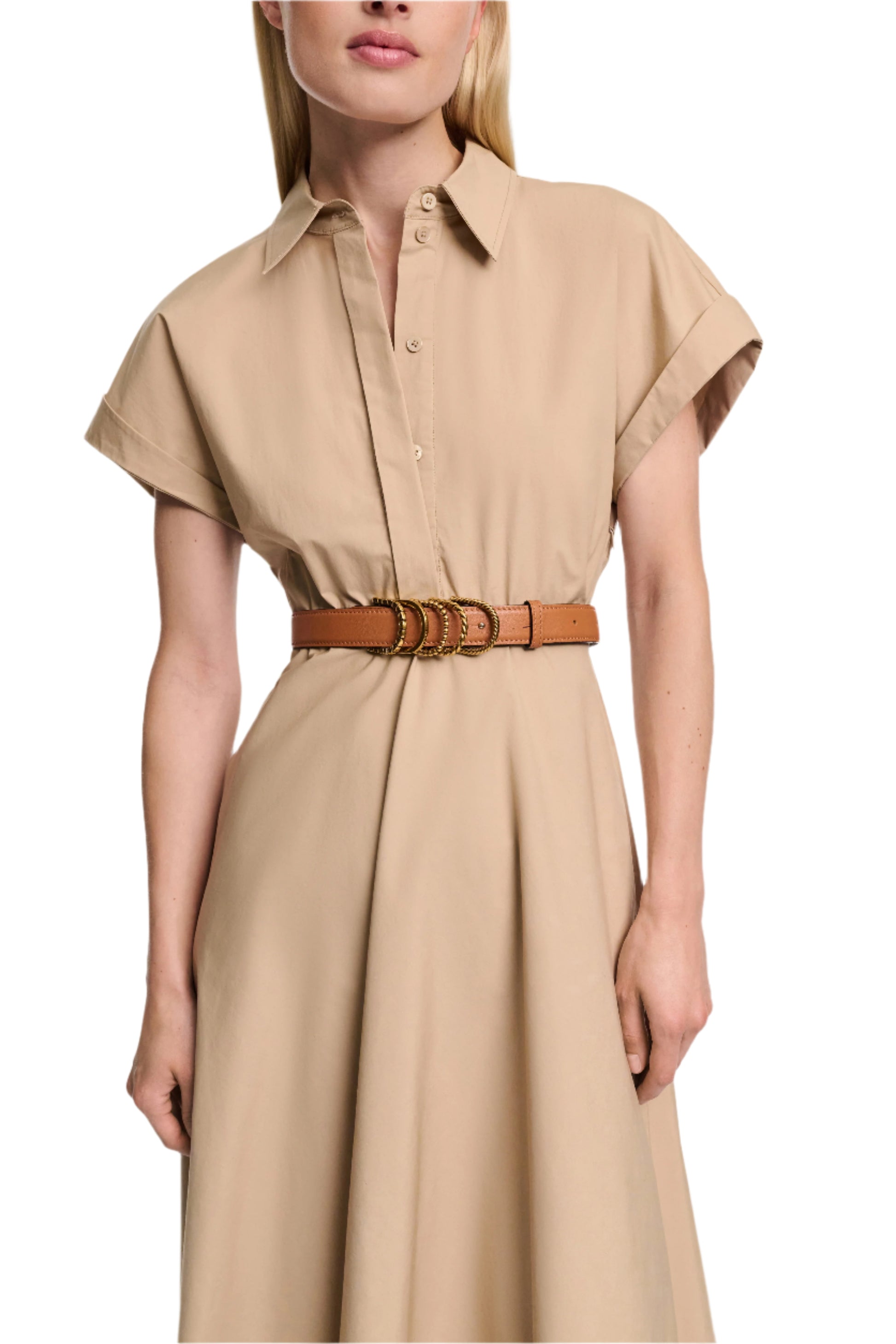 A woman wears the Dorothee Schumacher Poplin Power Dress, a beige cotton poplin shirtdress with short sleeves and a brown belt with gold rings that highlights the tailored waist.